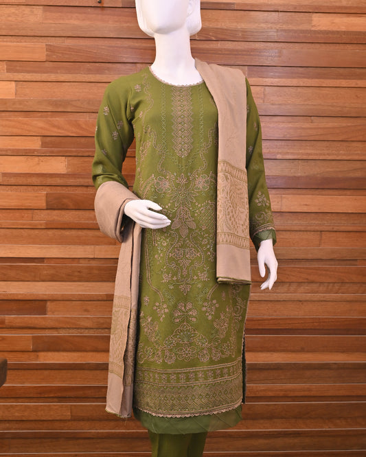 Green traditional outfit with a matching dupatta on a wooden floor